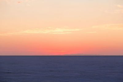 Scenic view of sea against romantic sky at sunset