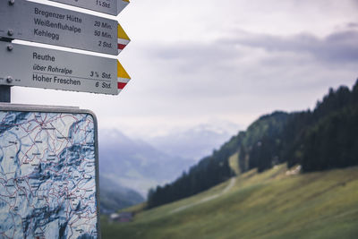 Information sign on landscape against sky