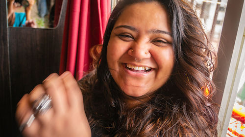 Portrait of smiling young woman using mobile phone