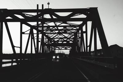 Silhouette bridge against sky