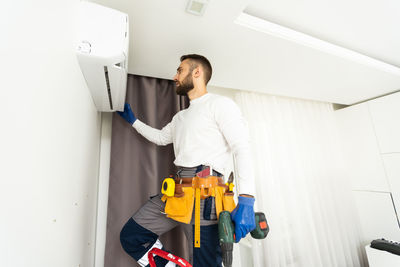 Side view of man working at home