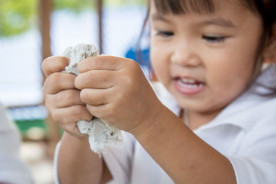 Close-up of girl playing with clay