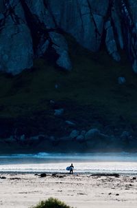 Man on beach against sky at night