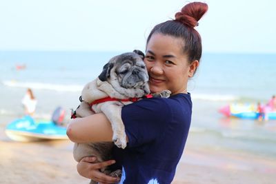 Woman with dog on beach