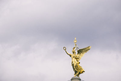 Low angle view of statue against sky