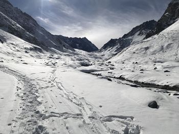 Scenic view of snow covered mountains against sky