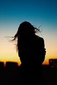 Silhouette of woman at sunset