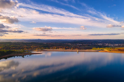 Drone aerial panoramic view of sabugal dam lake reservoir with perfect reflection, in portugal