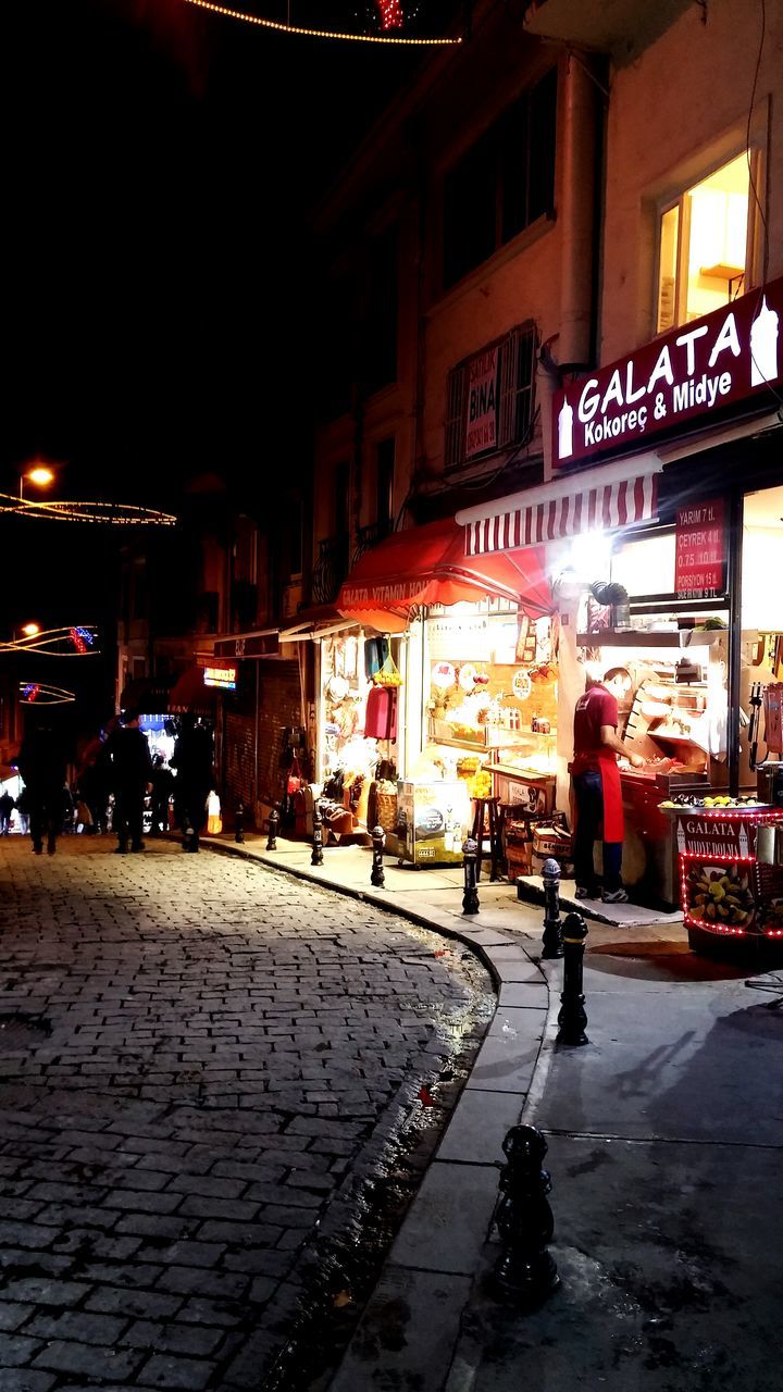 VIEW OF ILLUMINATED CITY AT NIGHT