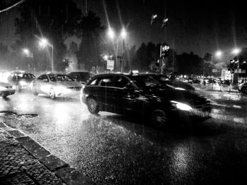 Cars on city street during rainy season at night