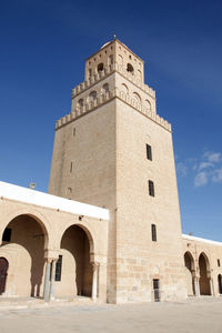 Low angle view of great mosque of kairouan against sky