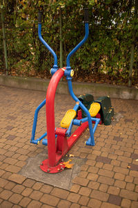 High angle view of empty park bench on footpath