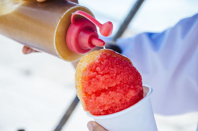 Close-up of strawberry holding ice cream