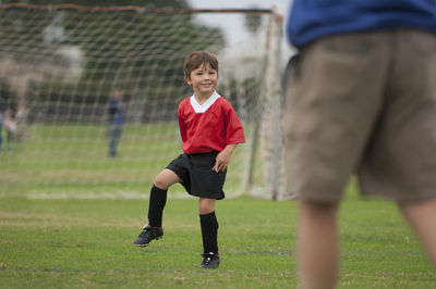 Young boy with big smile on a soccer field