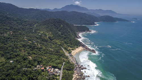 High angle view of sea and mountains against sky