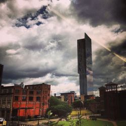 Buildings against cloudy sky