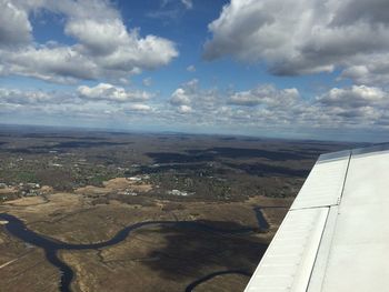 Aerial view of landscape against cloudy sky