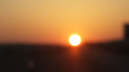 Scenic view of sea against orange sky