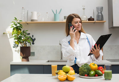 The nutritionist advises the patient online by phone. nutraceutical is in the kitchen 