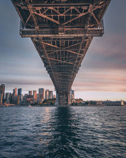 View of bridge over river against cloudy sky during sunset