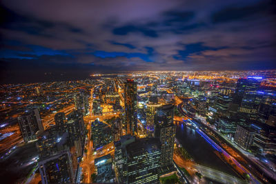 High angle view of city lit up at night