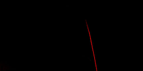 Close-up of red lights against black background