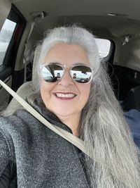 Portrait of a smiling young woman in car