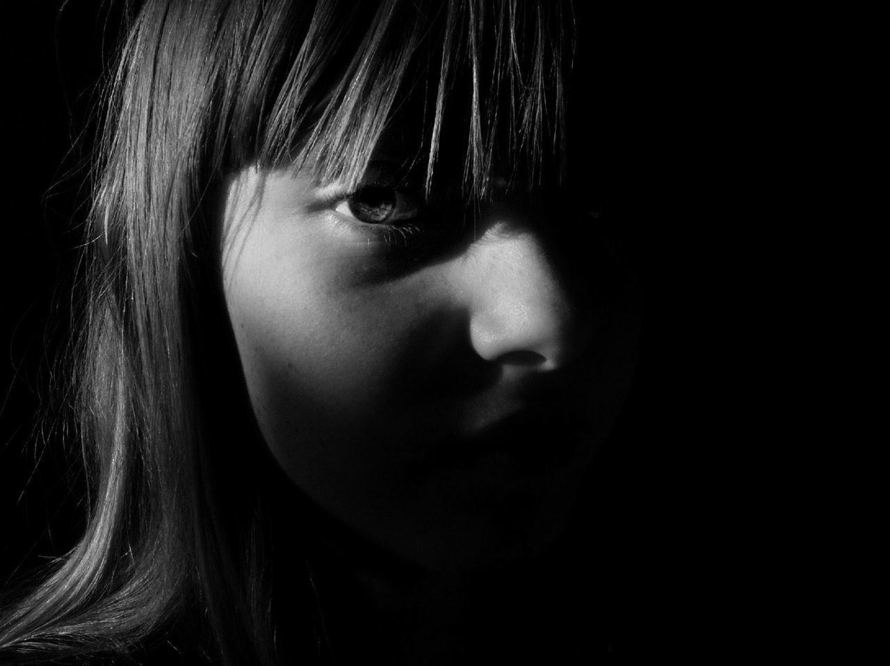 lifestyles, person, headshot, indoors, leisure activity, young adult, close-up, young women, front view, human face, black background, contemplation, childhood, studio shot, looking away, casual clothing, eyes closed, serious