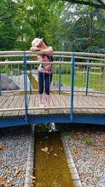 Woman sitting on railing