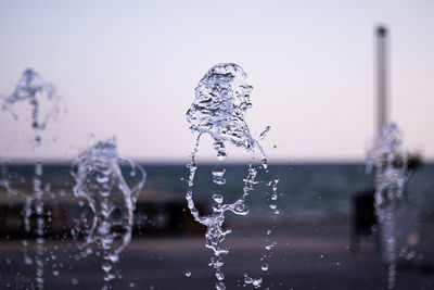 Close-up of water splashing against sky