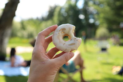 Cropped hand of person holding donut