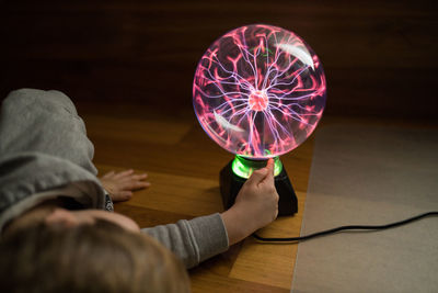 Midsection of woman holding illuminated table