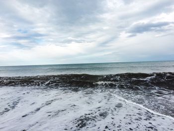 Scenic view of sea against cloudy sky