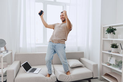 Full length of young woman exercising in gym