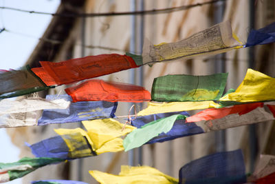 Close-up of colorful clothes hanging on paper