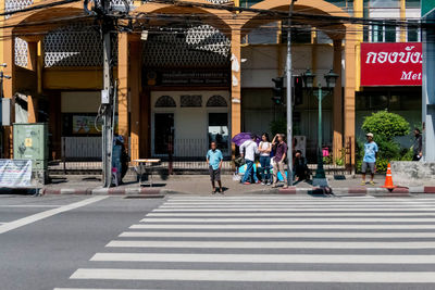 People crossing road in city