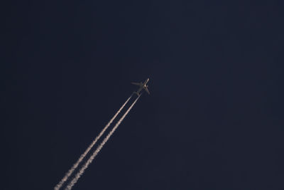 Low angle view of airplane flying in sky