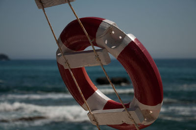 Close-up of umbrella on beach against sky