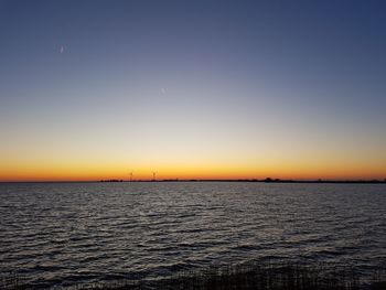 Scenic view of sea against clear sky during sunset