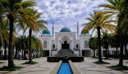 Facade of mosque against sky