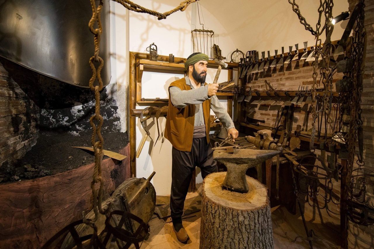 YOUNG MAN WORKING IN TRADITIONAL CLOTHING