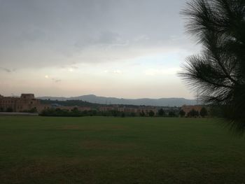 Scenic view of field against sky during sunset