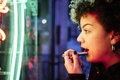 Portrait of woman holding cigarette