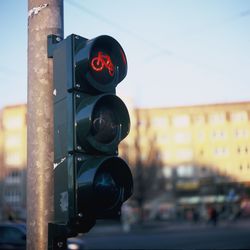 Close-up of illuminated road signal against sky