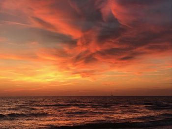 Scenic view of sea against orange sky