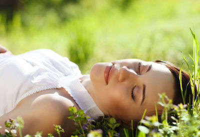 Young woman sleeping on grass