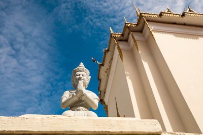 Low angle view of statue against building