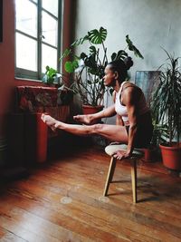 Young woman sitting on table