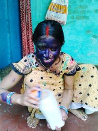 Portrait of a smiling young man drinking water