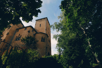 Low angle view of built structure against trees